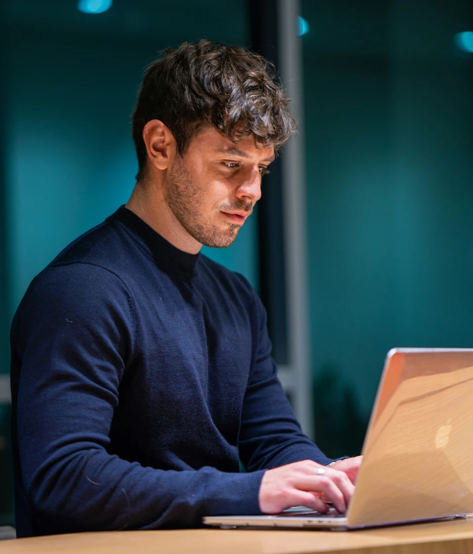 Cyber security expert working on laptop